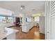 Well lit kitchen featuring white cabinets, appliances, breakfast bar, and an adjacent office space at 6627 Leeside Isle, Hudson, FL 34667