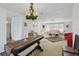 Open floor plan living room with decorative lighting fixture, neutral colored sofas and chairs, plus area rug at 6627 Leeside Isle, Hudson, FL 34667