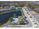 Aerial view of lakeside townhome community, showcasing pool and proximity to a tranquil lake at 6741 Citrus Creek Ln, Tampa, FL 33625