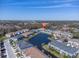 Panoramic aerial view of the community featuring townhomes, a pond, and serene surroundings at 6741 Citrus Creek Ln, Tampa, FL 33625