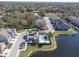 Aerial view of a neighborhood featuring a community pool, townhomes, and a picturesque lake at 6741 Citrus Creek Ln, Tampa, FL 33625