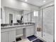 Bright bathroom with double sinks, granite countertops, and glass shower doors at 6741 Citrus Creek Ln, Tampa, FL 33625