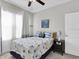 Charming bedroom with bright windows, coastal decor, ceiling fan, and a nightstand at 6741 Citrus Creek Ln, Tampa, FL 33625