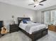Cozy bedroom featuring a ceiling fan, soft carpet, and a large bed with dark wood frame at 6741 Citrus Creek Ln, Tampa, FL 33625