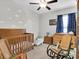 Charming Bedroom with a wooden crib, rocking chair, and cloud decorations at 6741 Citrus Creek Ln, Tampa, FL 33625
