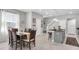 Open-concept dining area and kitchen with stairs in the background at 6741 Citrus Creek Ln, Tampa, FL 33625