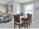 Well-lit dining room featuring a dark wood table, seating for six, and tile floors at 6741 Citrus Creek Ln, Tampa, FL 33625