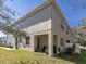 Exterior view of the backyard featuring a patio with seating, lush grass, and privacy fence at 6741 Citrus Creek Ln, Tampa, FL 33625