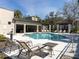 Well-maintained community pool area featuring lounge chairs, tables, and shaded seating at 6741 Citrus Creek Ln, Tampa, FL 33625
