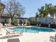 Community pool with plenty of lounge chairs and shaded areas for relaxation at 6741 Citrus Creek Ln, Tampa, FL 33625