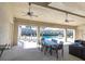 View of a covered outdoor seating area with ceiling fans and a table overlooking the community pool at 6741 Citrus Creek Ln, Tampa, FL 33625