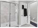 Modern shower featuring a rainfall showerhead, glass door, and towel rack at 6741 Citrus Creek Ln, Tampa, FL 33625