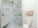 Bathroom featuring a glass shower with built-in bench, marbled tile, and modern toilet at 700 S Harbour Island Blvd # 807, Tampa, FL 33602