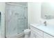 Modern bathroom featuring a marble-tiled shower with glass enclosure and a white vanity at 700 S Harbour Island Blvd # 807, Tampa, FL 33602