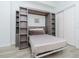 Stylish bedroom featuring a Murphy bed, built-in bookshelves, and modern decor at 700 S Harbour Island Blvd # 807, Tampa, FL 33602