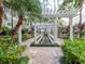 Exterior shot of a courtyard featuring a reflecting pool, white pergola, and lush landscaping at 700 S Harbour Island Blvd # 807, Tampa, FL 33602