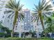 Stunning building featuring lush landscaping, palm trees, and wrought iron fence at 700 S Harbour Island Blvd # 807, Tampa, FL 33602