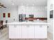 Modern kitchen features a large island, white cabinets, stainless steel appliances, and updated fixtures at 700 S Harbour Island Blvd # 807, Tampa, FL 33602