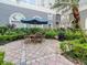 Outdoor patio featuring a table with umbrella, surrounded by landscaping and privacy hedges at 700 S Harbour Island Blvd # 807, Tampa, FL 33602