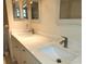 Bathroom featuring double sinks with granite counter tops and updated fixtures at 7106 Green Abbey Way, Spring Hill, FL 34606