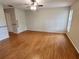 Large bedroom with wood flooring, ceiling fan, and access to other rooms of the home at 7106 Green Abbey Way, Spring Hill, FL 34606