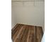 Empty walk-in closet provides ample storage with wire shelving and a wooden floor at 7106 Green Abbey Way, Spring Hill, FL 34606