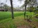 Picturesque golf course featuring a green, mature trees, and players enjoying a game in a tranquil setting at 7106 Green Abbey Way, Spring Hill, FL 34606