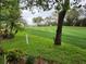 Beautifully manicured golf course fairway showcasing lush green grass, mature trees, and a serene environment at 7106 Green Abbey Way, Spring Hill, FL 34606