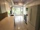 Bright kitchen with white cabinets, stainless steel appliances, quartz countertops, and tile floors at 7106 Green Abbey Way, Spring Hill, FL 34606