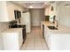 Modern kitchen with white cabinets, stainless steel appliances, and quartz countertops at 7106 Green Abbey Way, Spring Hill, FL 34606