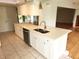 Bright kitchen featuring white cabinets, stainless steel appliances, and tile floors at 7106 Green Abbey Way, Spring Hill, FL 34606
