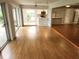 Bright living room with hard wood floors, adjacent to kitchen and sliding glass doors at 7106 Green Abbey Way, Spring Hill, FL 34606