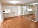 Bright living room featuring hard wood floors and views into the kitchen at 7106 Green Abbey Way, Spring Hill, FL 34606