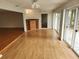 Spacious living room with hardwood floors, built in storage and a large sliding glass doors at 7106 Green Abbey Way, Spring Hill, FL 34606