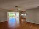 Open-concept living room with hardwood floors and a view of the yard at 7106 Green Abbey Way, Spring Hill, FL 34606