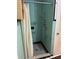 Shower with aqua tiling and grab bars at 7204 Grand Blvd, New Port Richey, FL 34652