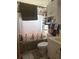 Compact bathroom featuring a shower-tub combo with themed curtain, standard toilet, and vanity offering everyday convenience at 7278 Lamplighter St, Spring Hill, FL 34606
