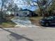 Street view of a single-story home with a driveway, attached garage and a basketball hoop at 7278 Lamplighter St, Spring Hill, FL 34606