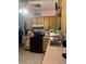 Functional kitchen space featuring wood cabinets, black appliances, with a black and white backsplash, for convenience and style at 7278 Lamplighter St, Spring Hill, FL 34606