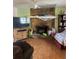 Inviting living area with a stone fireplace, wooden floors, TV and comfortable seating arrangement, perfect for relaxation at 7278 Lamplighter St, Spring Hill, FL 34606