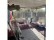 Enclosed patio with seating, swing, carpet and furniture at 7278 Lamplighter St, Spring Hill, FL 34606