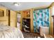 Cozy bedroom featuring a bookshelf, patterned rug, and an adjoining living room at 7381 Lykes Dublin Rd, Brooksville, FL 34601