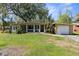 Single story home with large front porch, attached garage, and large front lawn at 7381 Lykes Dublin Rd, Brooksville, FL 34601