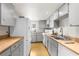 Bright kitchen with white cabinets, stainless steel sink, and light wood floors at 7381 Lykes Dublin Rd, Brooksville, FL 34601