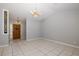 Spacious living area with tile floors, chandelier lighting, and a decorative front door at 7931 Rusty Oak Dr, New Port Richey, FL 34653