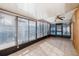 Sunroom features tile floors and walls of windows, great for enjoying the outdoors inside at 7931 Rusty Oak Dr, New Port Richey, FL 34653