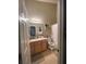 Bathroom featuring single sink, vanity with wood cabinets, and shower and tub combo at 8337 Shallow Creek Ct, New Port Richey, FL 34653