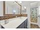 Bathroom with white countertops, vanity with dark blue cabinets, and a walk-in shower at 9291 Geranium Ave, Spring Hill, FL 34606