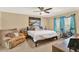Spacious bedroom with a king bed, comfy chair, and a large window with natural light at 9291 Geranium Ave, Spring Hill, FL 34606