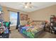 Comfortable bedroom featuring a colorful theme, large window, and desk space at 9291 Geranium Ave, Spring Hill, FL 34606